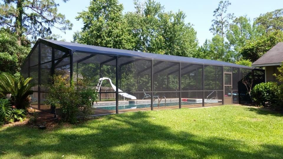 Dark bronze pool screen enclosure with a slide, side view