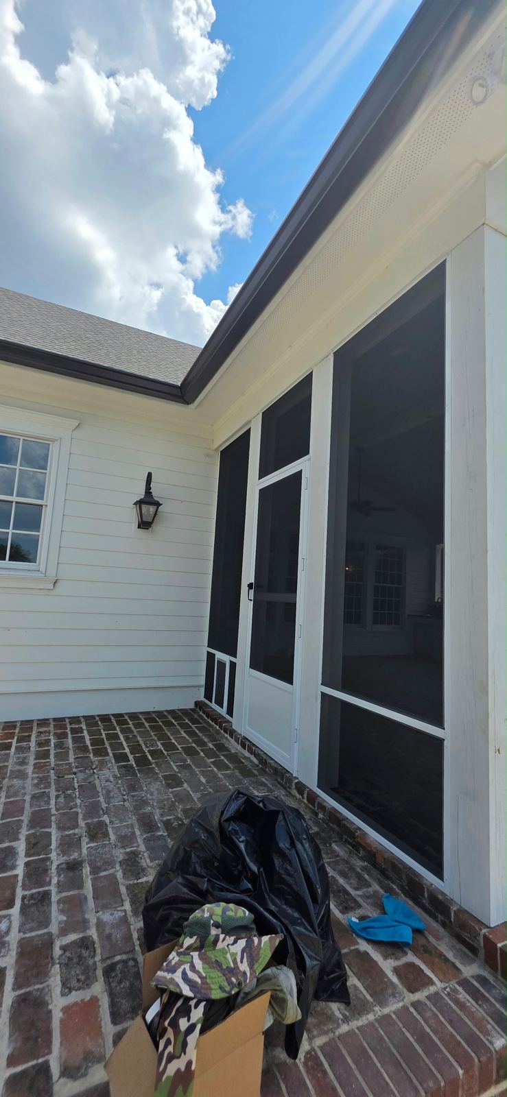 Side view of a screened porch on a brick home