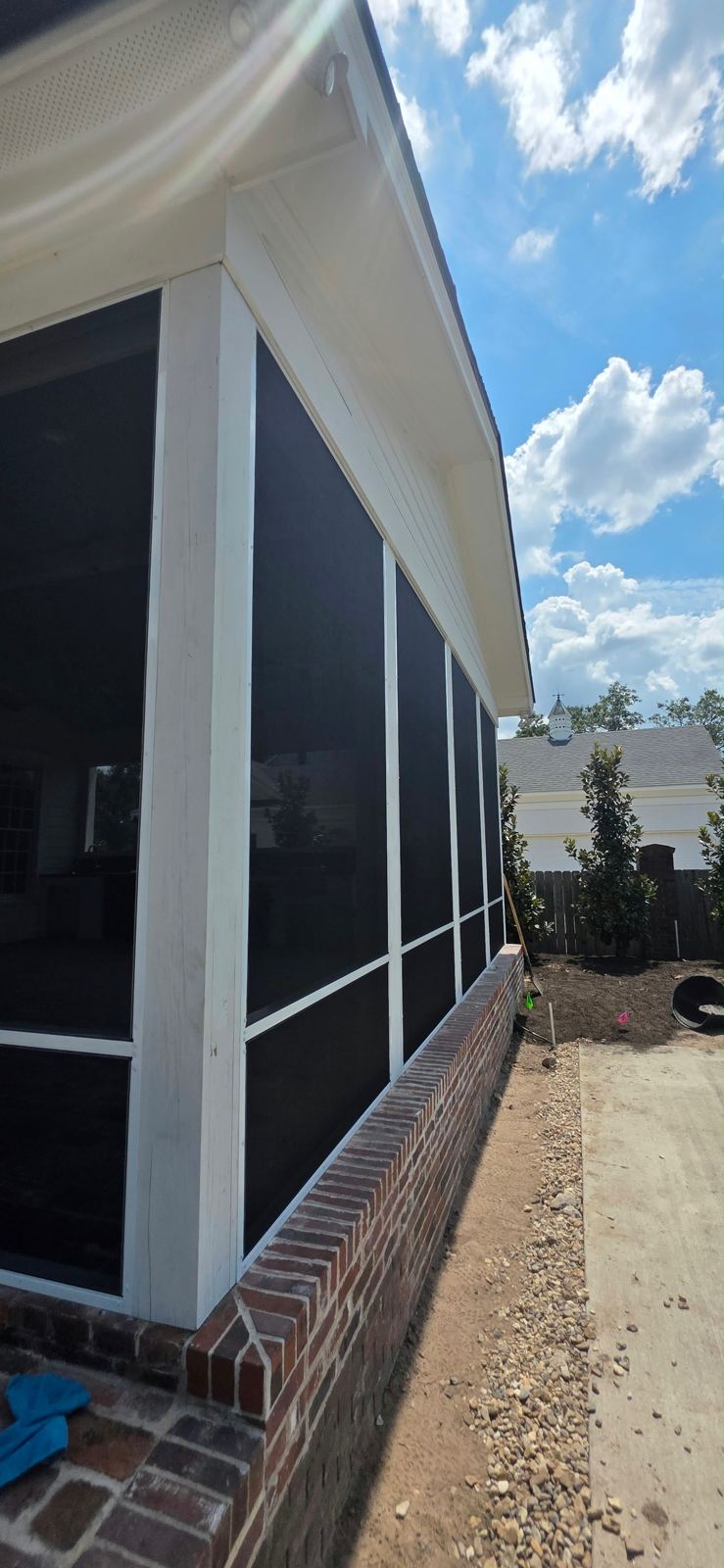 Screen porch wall section beside a brick wall