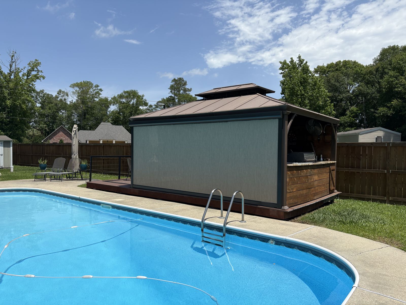 Light shade lowered on a poolside gazebo