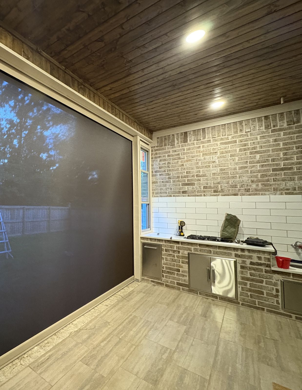Dark shades lowered on a covered patio at dusk